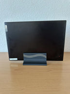 Black 3D printed vertical laptop stand holding a laptop upright, front view