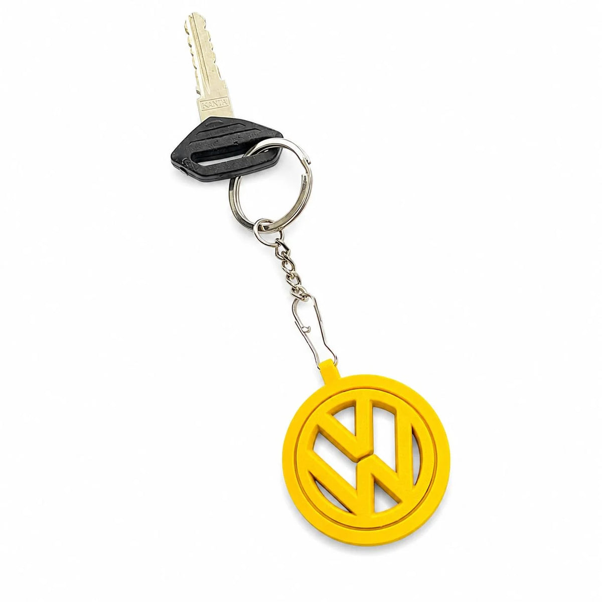 Yellow round logo keychain attached to a car key