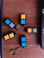 2-key mechanical keychains in assorted colours on a wooden table