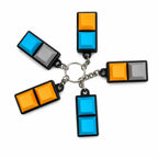 Five 2-key mechanical keychains in orange, blue and grey combinations