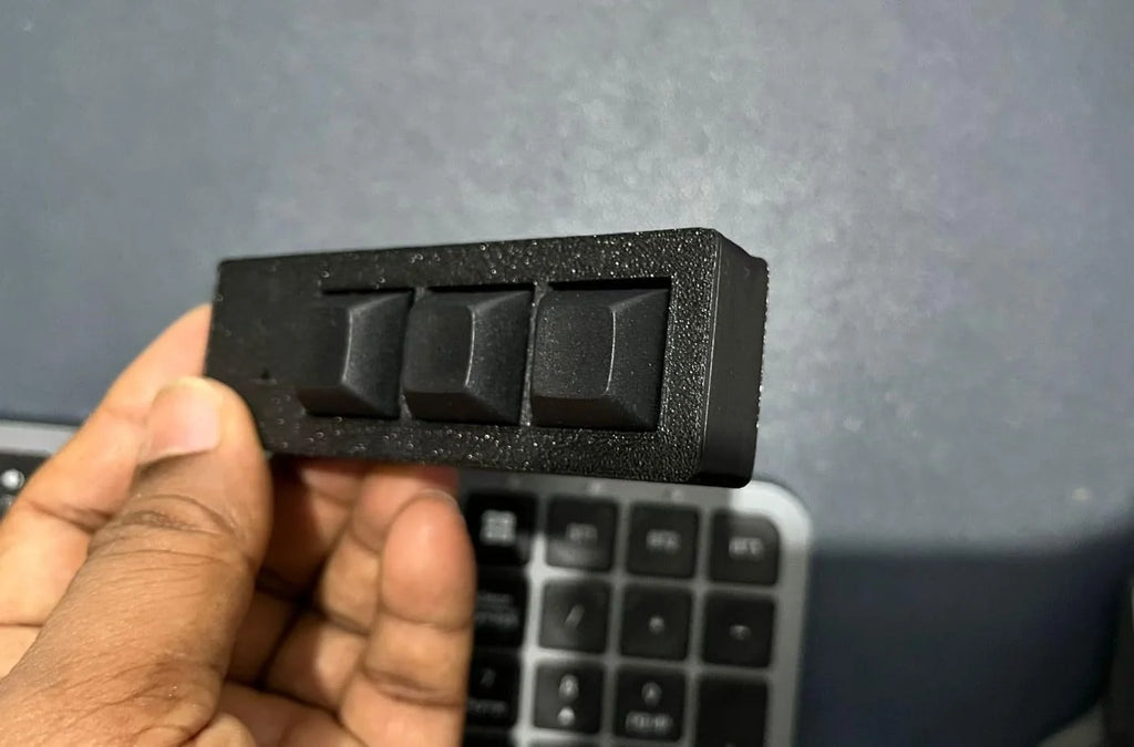 PicoPad 3x1 flat macro pad held in hand, angled view