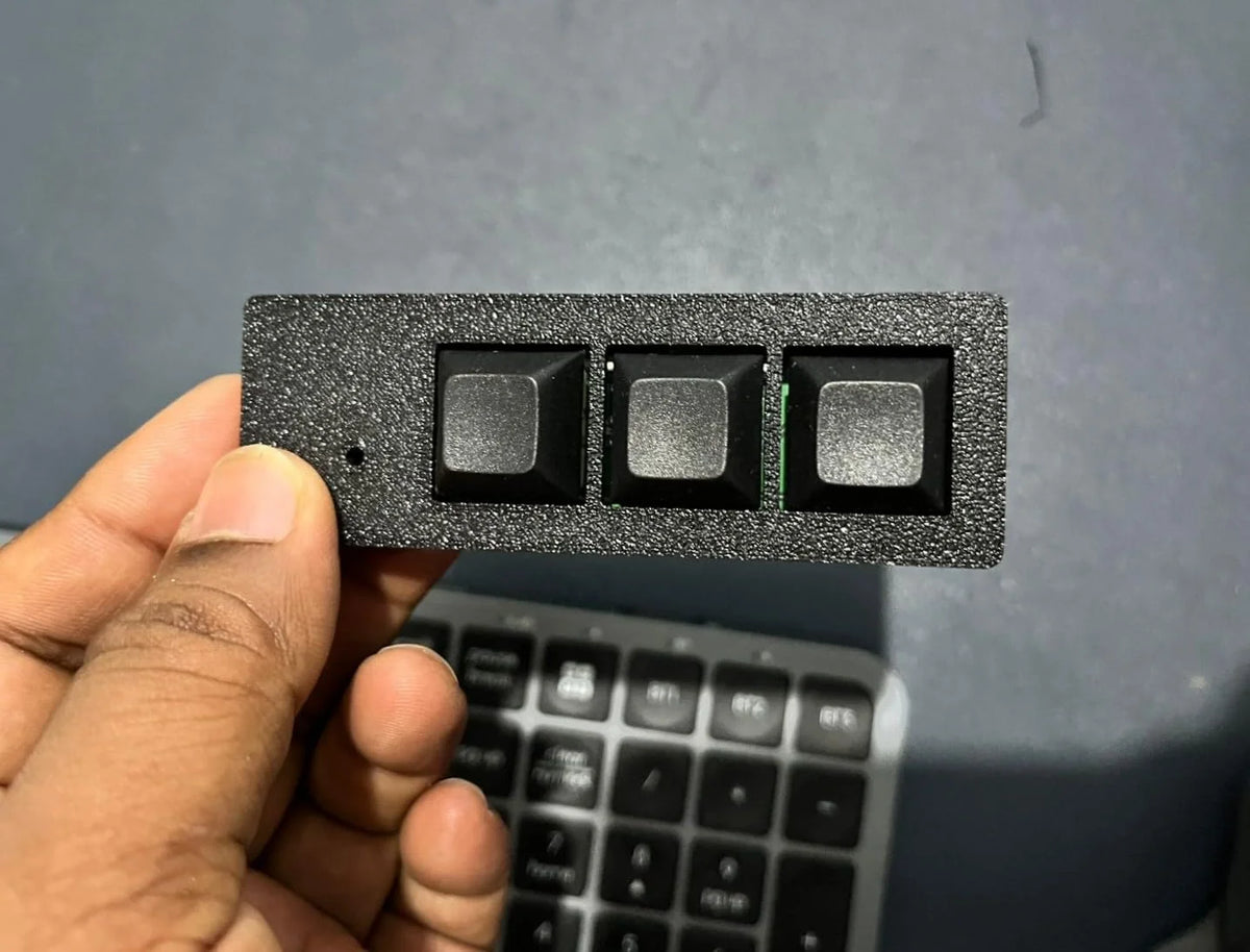 PicoPad 3x1 flat 3-key macro pad held above a keyboard